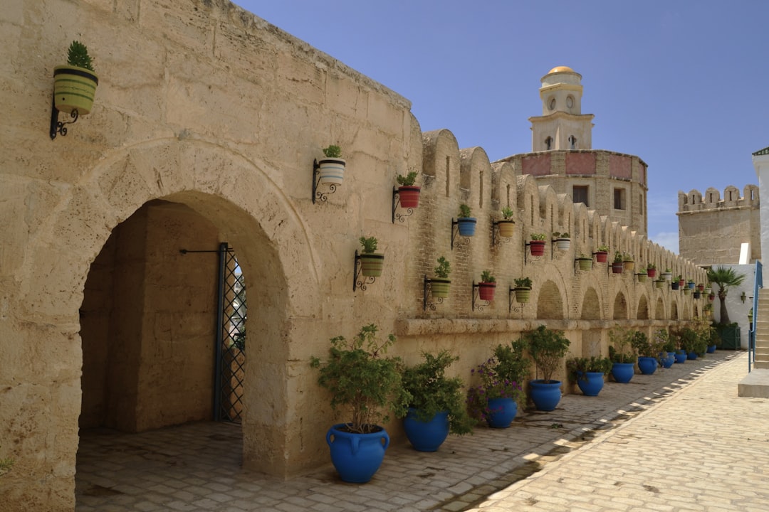 Stone archways and blue ceramic pots lining the medina walls, Yasmine Hammamet, Tunisia