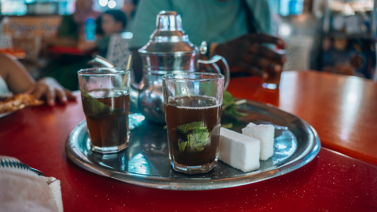 Mint tea and sweets served on a tray — café culture and tipping etiquette in Tunisia