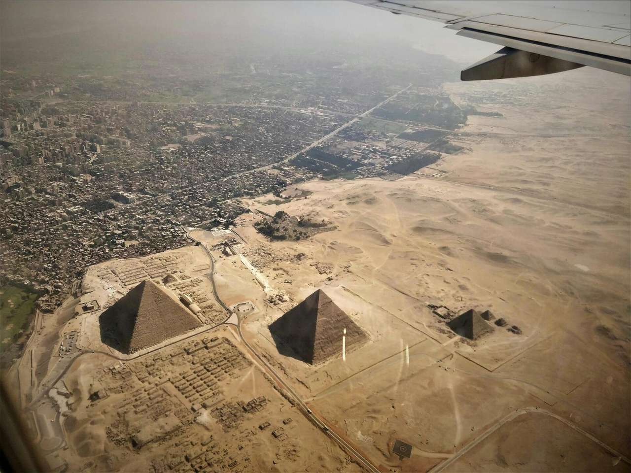 Aerial view of the pyramids of Giza, Egypt, from a passenger aircraft window