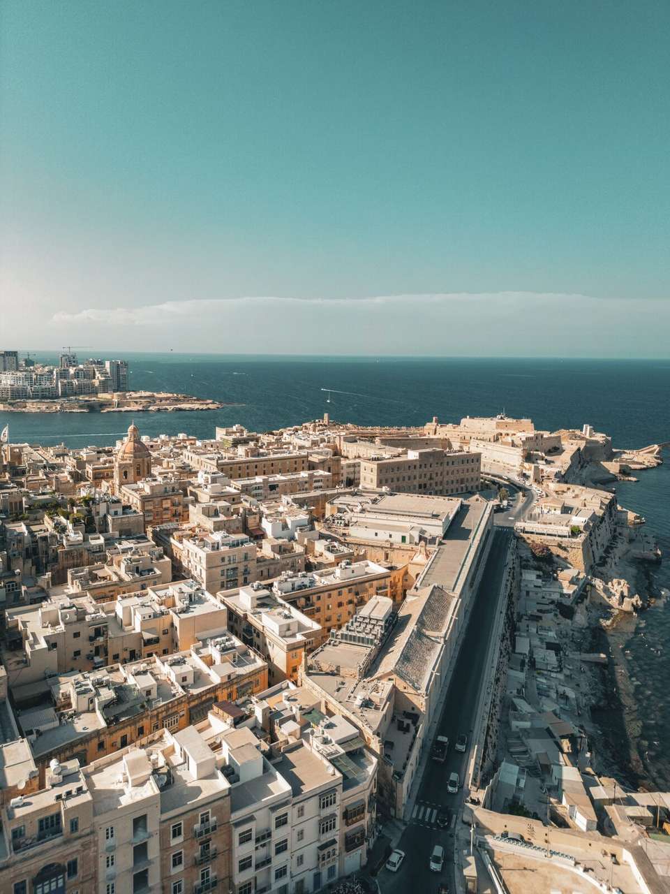 Aerial view of Valletta, Malta - golden limestone buildings and harbour stretching to the Mediterranean Sea