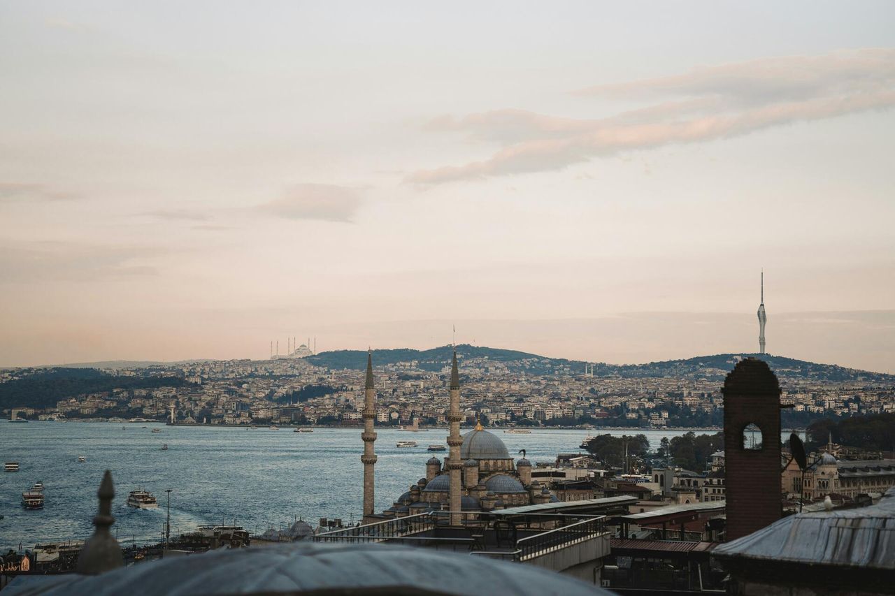 Istanbul skyline with Ottoman mosque domes, minarets and the Bosphorus strait at dusk, Turkey