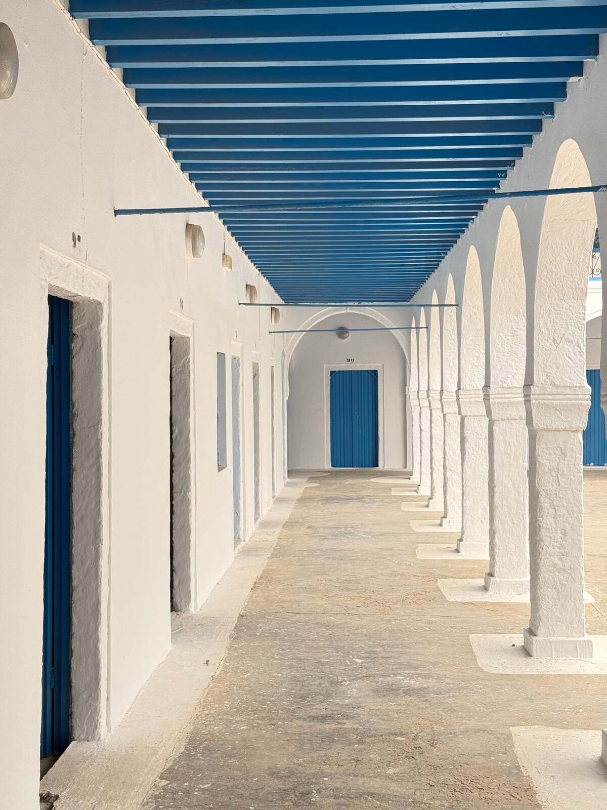 White arcades with blue ceilings in Erriadh, Djerba, Tunisia