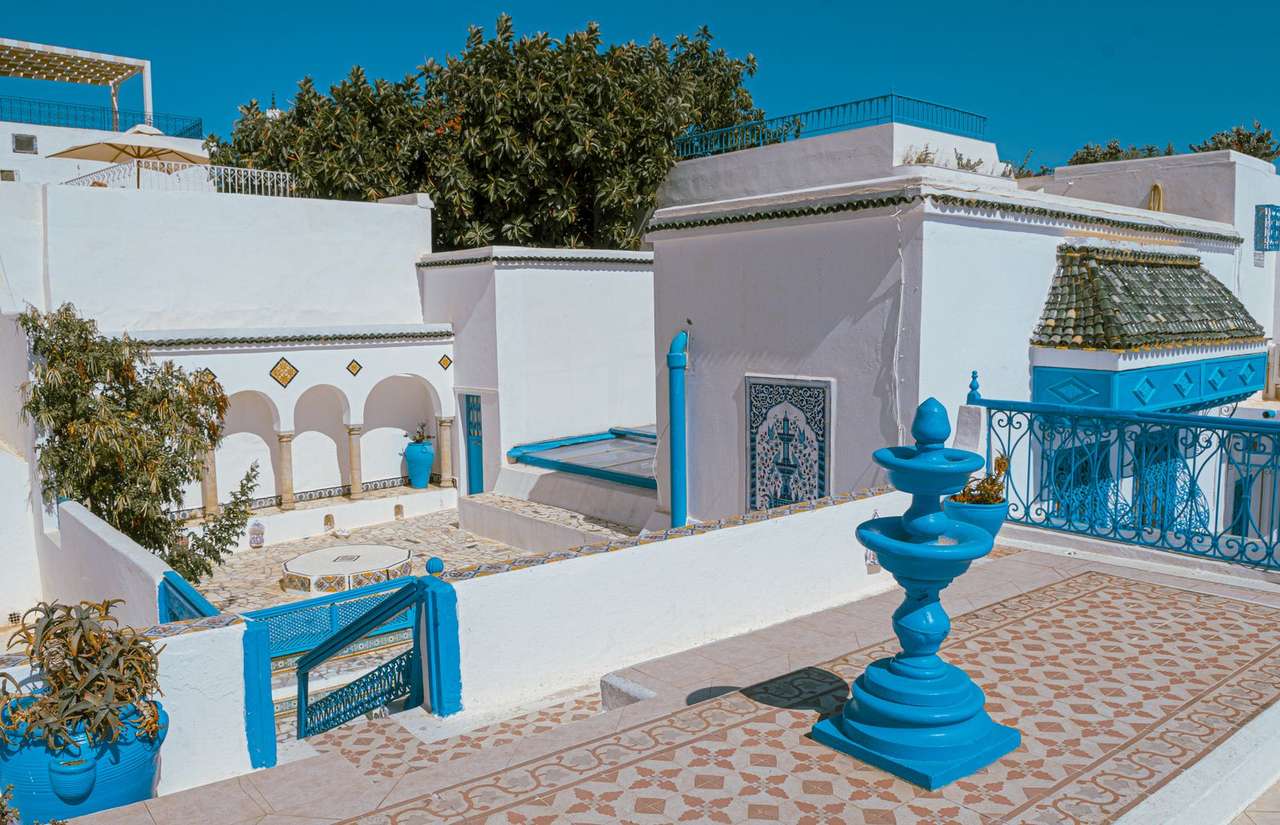 Blue and white courtyard with tiled fountain in Sidi Bou Said, Tunisia