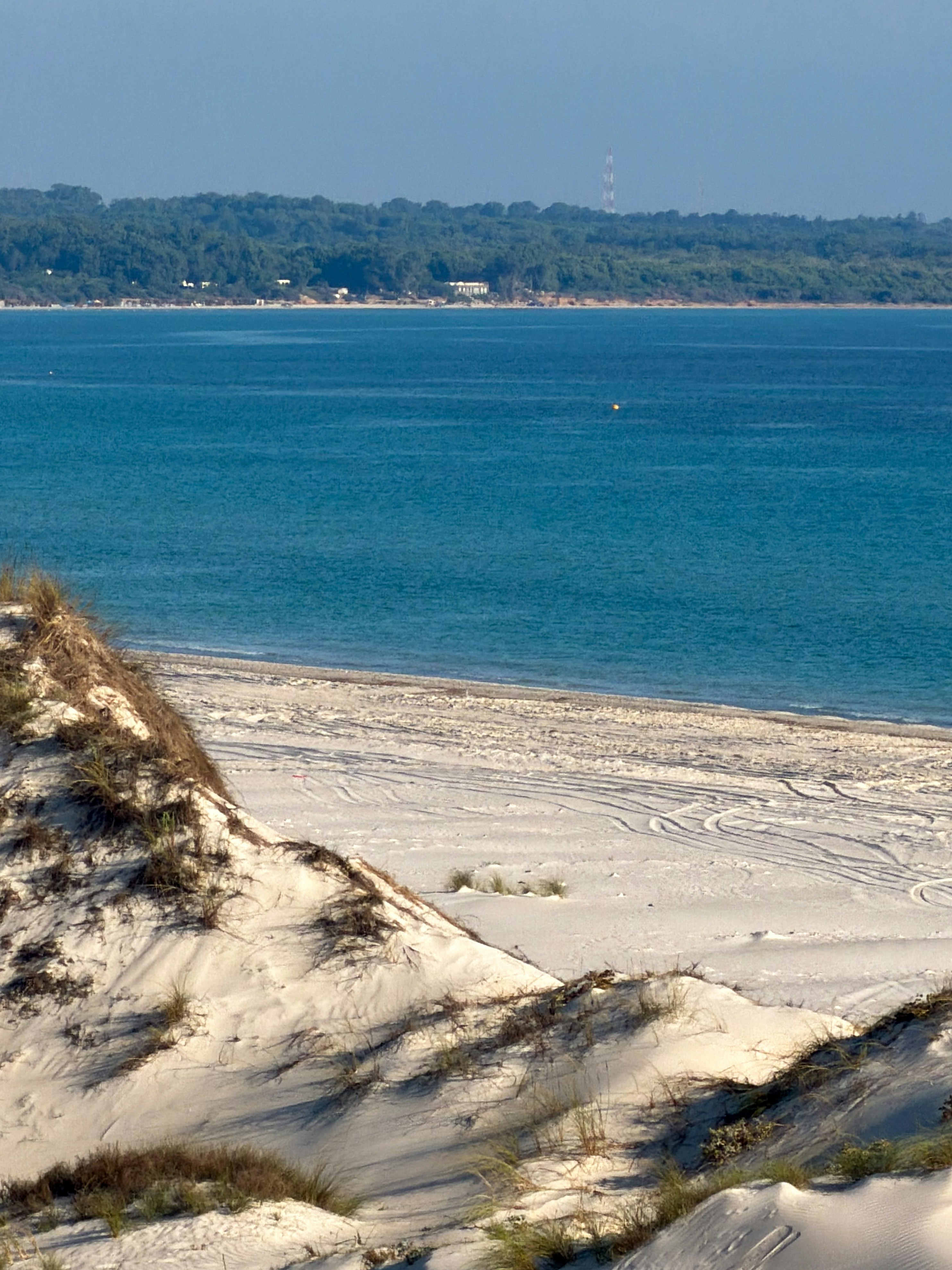 White sand dunes overlooking the calm blue Mediterranean from the Tunisian coast near Kerkennah