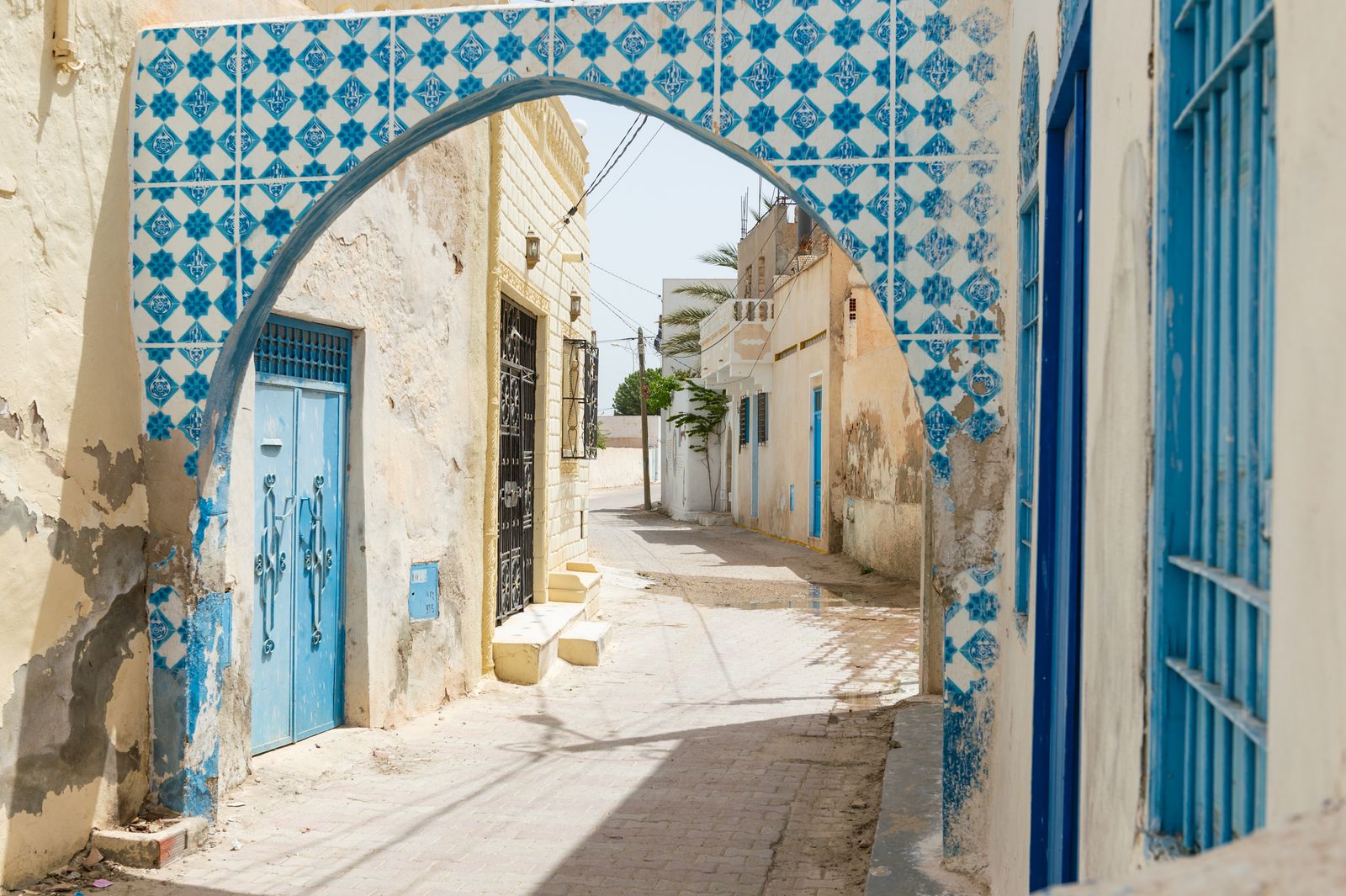 Blue-tiled archway in the whitewashed medina of Houmt Souk, Djerba island, Tunisia