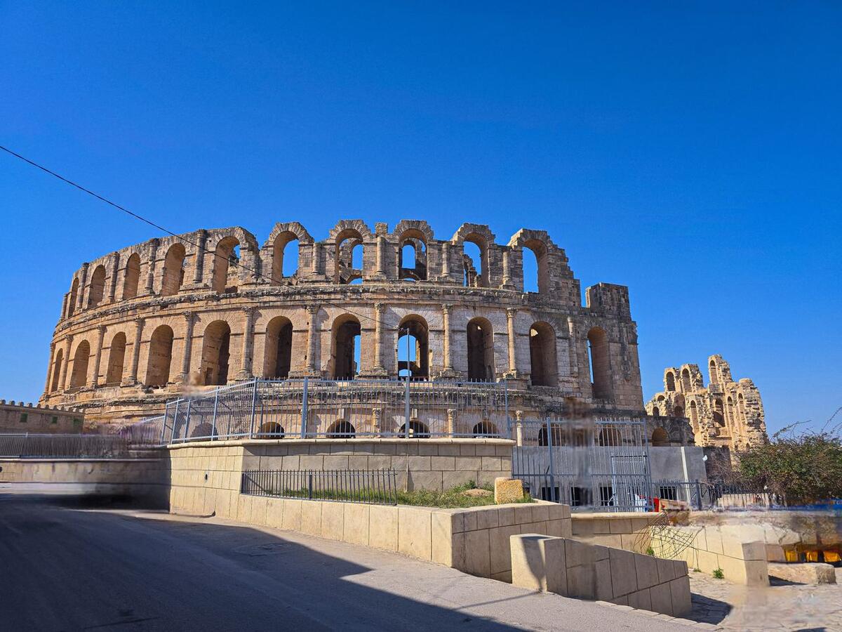 The Roman amphitheatre at El Jem under a clear blue sky, Tunisia